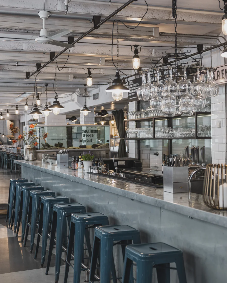 The bar counter with hanging glasses and a large shell